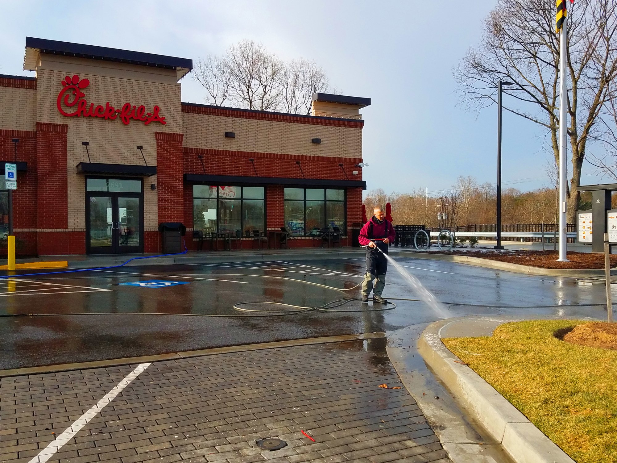 Professional pressure washing parking lot for restaurant Chick-fil-a