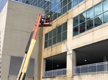 Profession on lift power washing corporate building